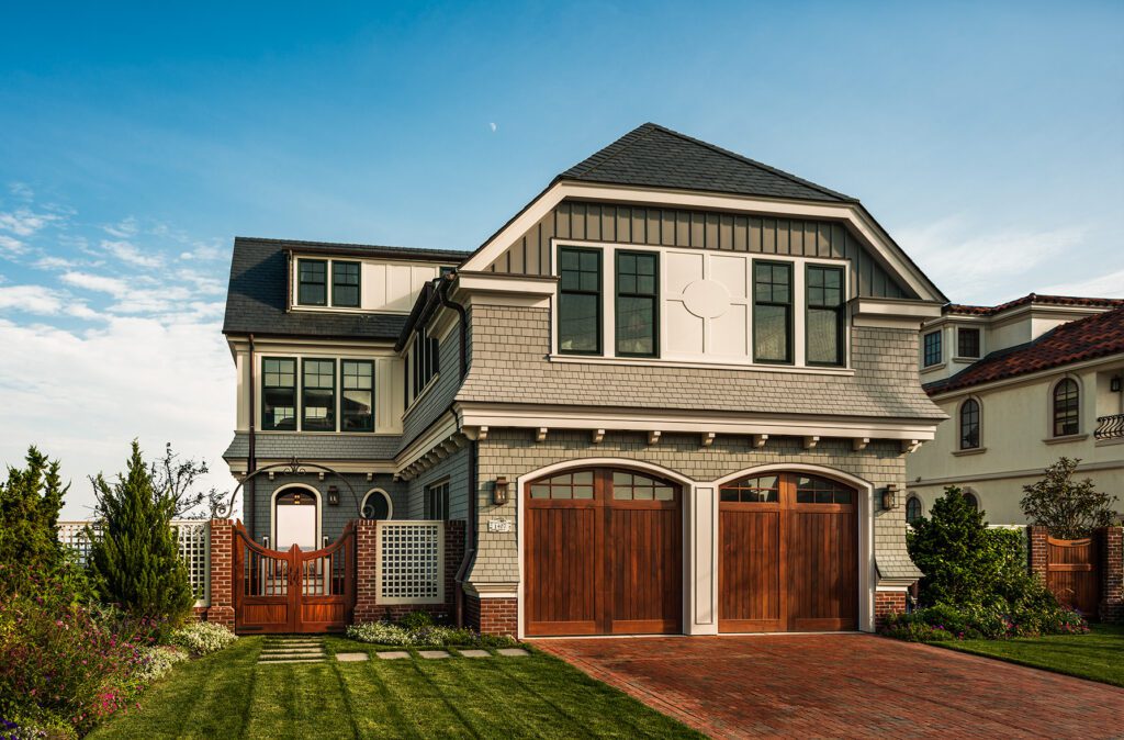 Shingle Facade with Timber Gates and Brickwork Detailing
