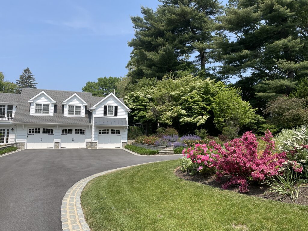 Color-Rich Entry Border Framing the Garage Wing with Seasonal Flair