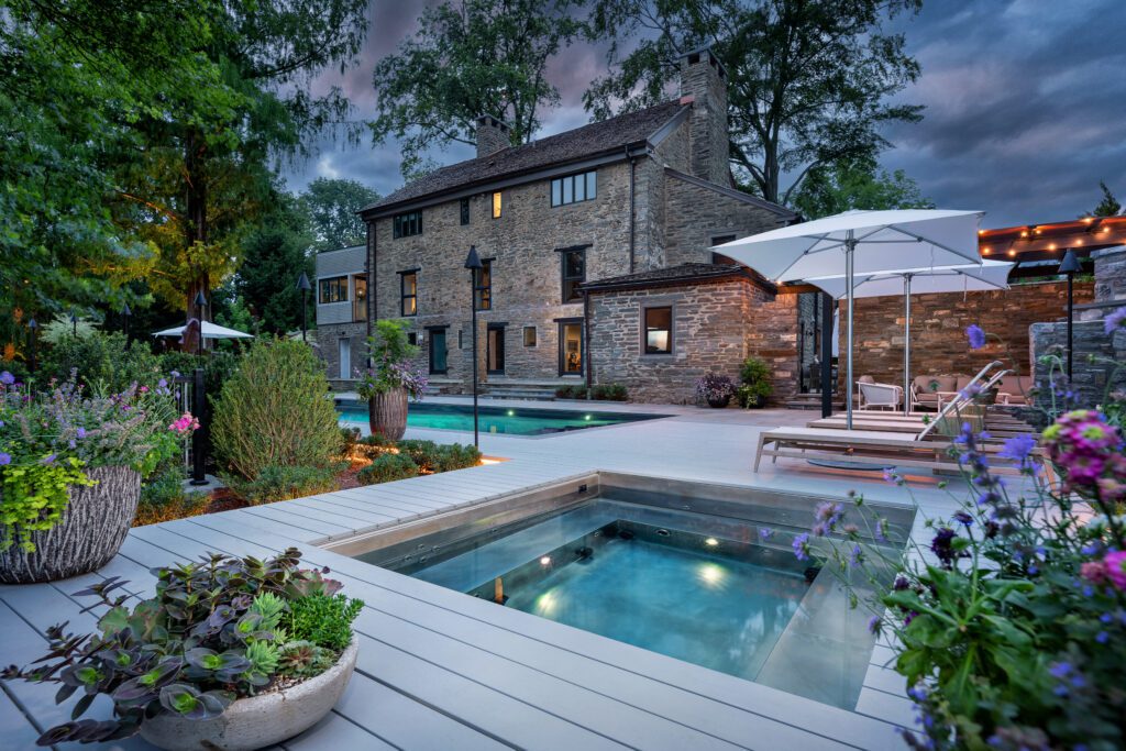 Contemporary Spa Integration Framing a Restored Stone Manor