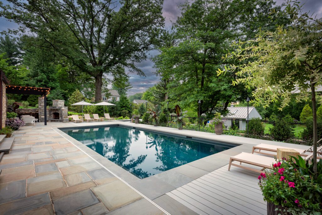 Refined Poolside Composition Framed by Slate, Shade, and Garden Texture