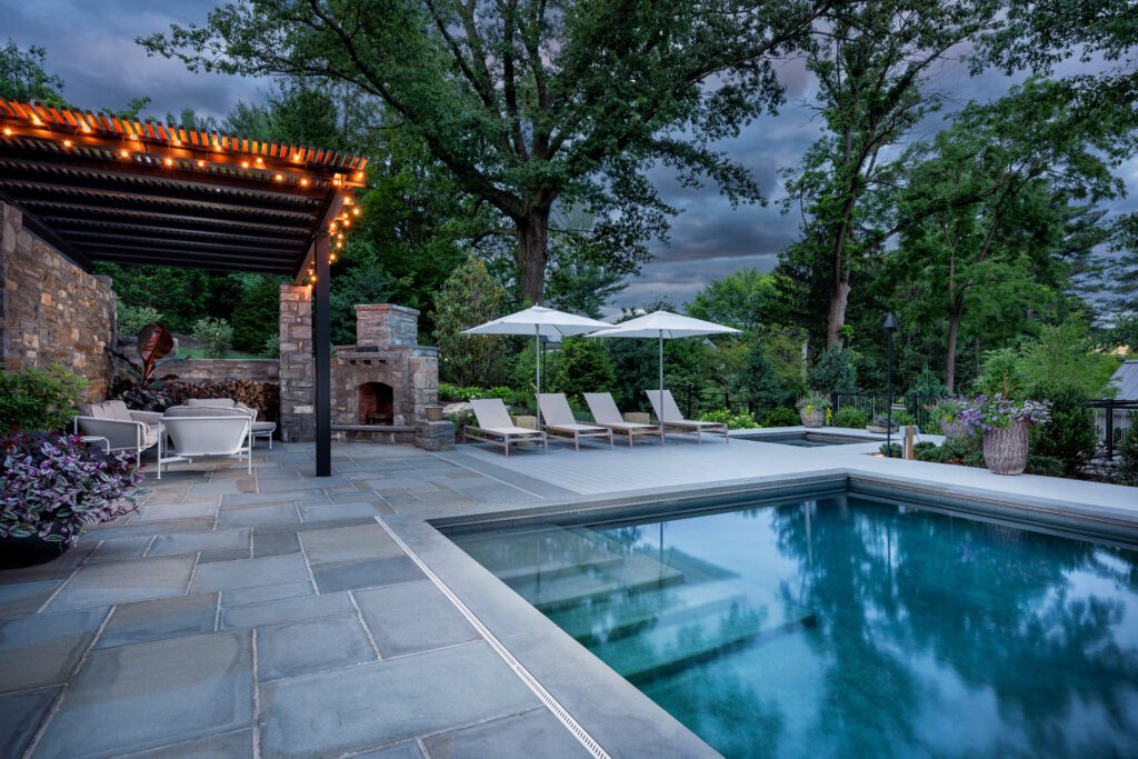 Layered Outdoor Living Anchored by Stonework and Canopy Structure