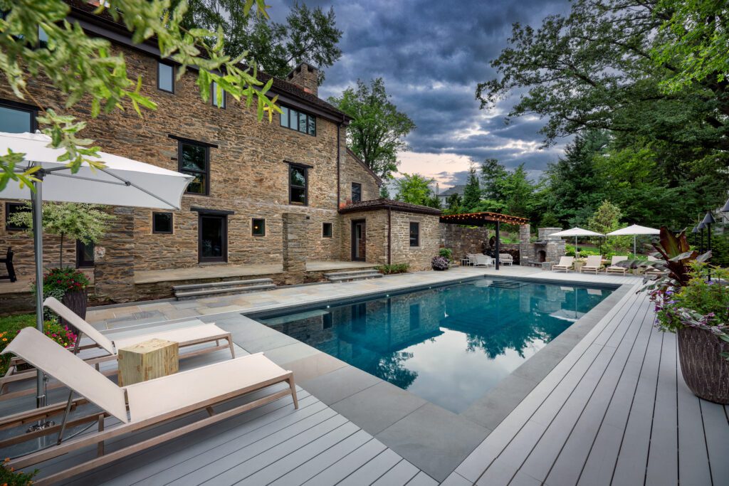 Unified Pool Terrace Framing the Historic Stone Façade